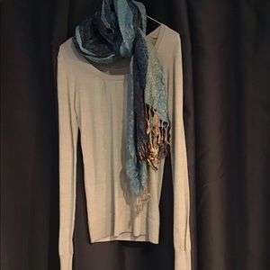 Grey sweater and turquoise scarf
